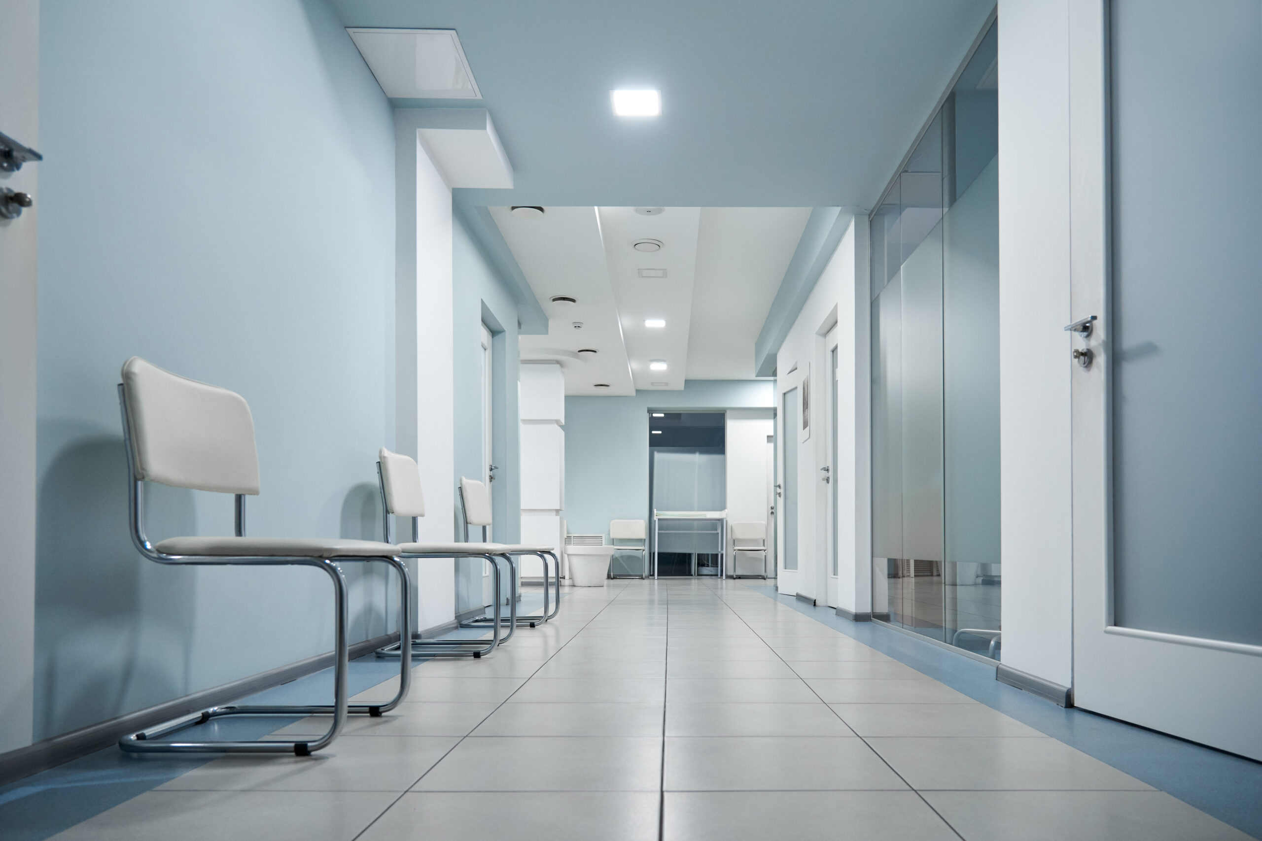 Empty modern hospital corridor, clinic hallway interior background.